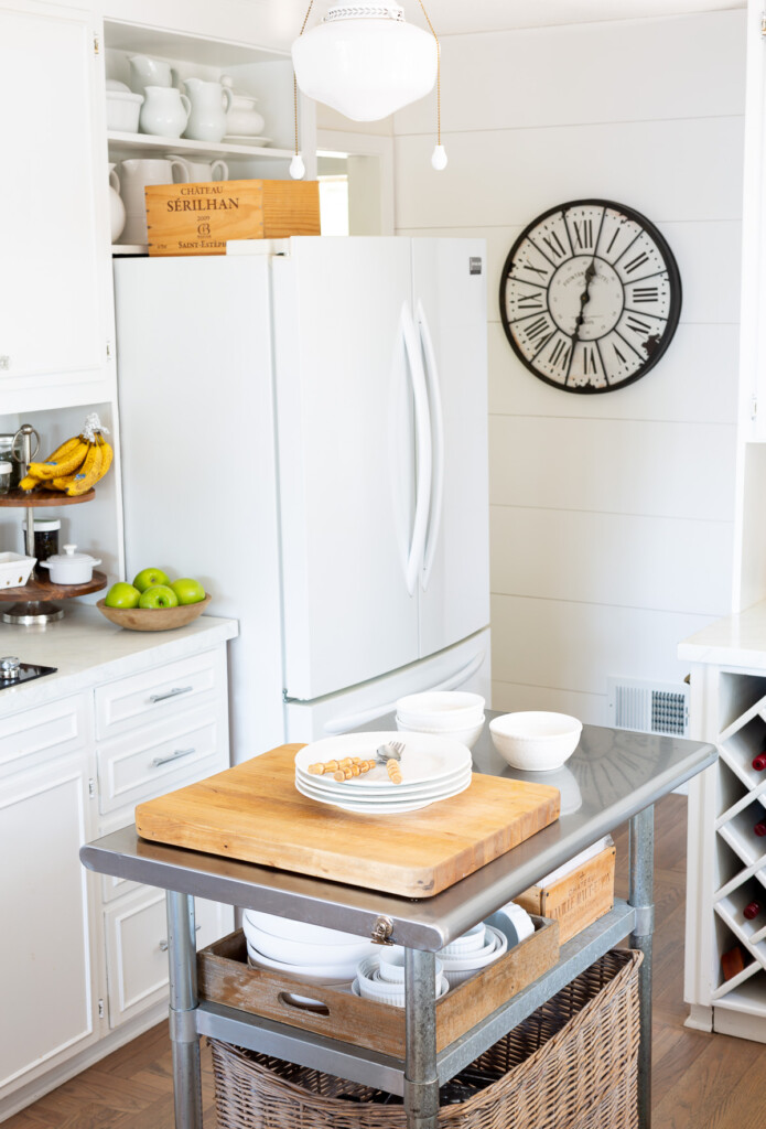 Small kitchen with rolling metal island to add more counter and meal prep space.