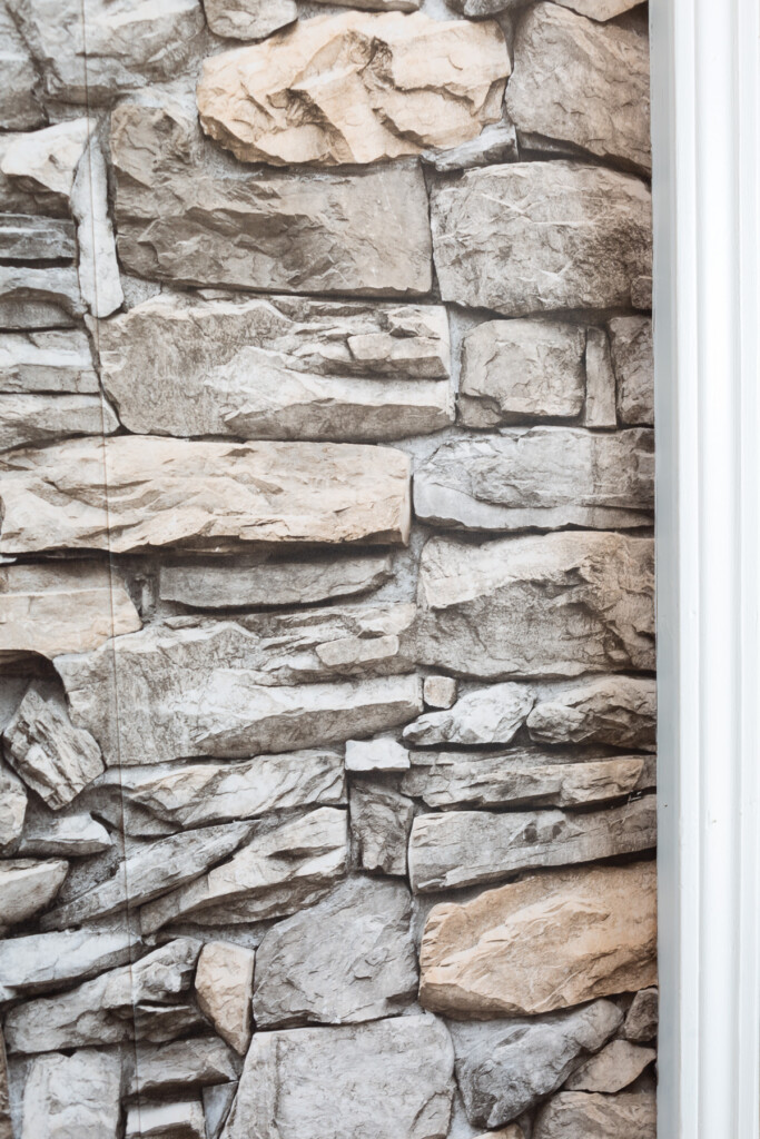 Close up pf the stacked stone peel and stick wallpaper on a kitchen wall.