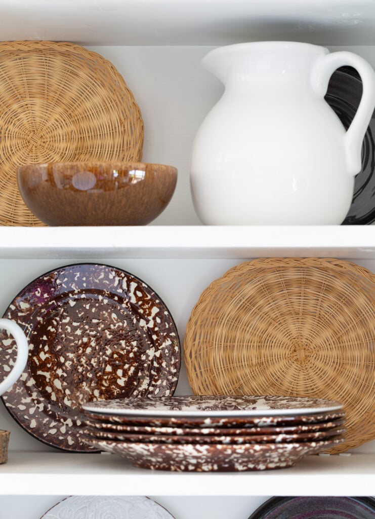 Open kitchen shelf's styled for fall with a white and brown color scheme.