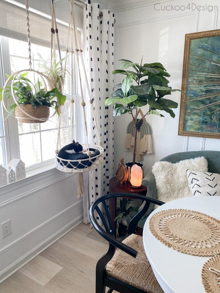 Cuckoo for Design's dining area with macrame DIY cat bed hanging in front of a window.