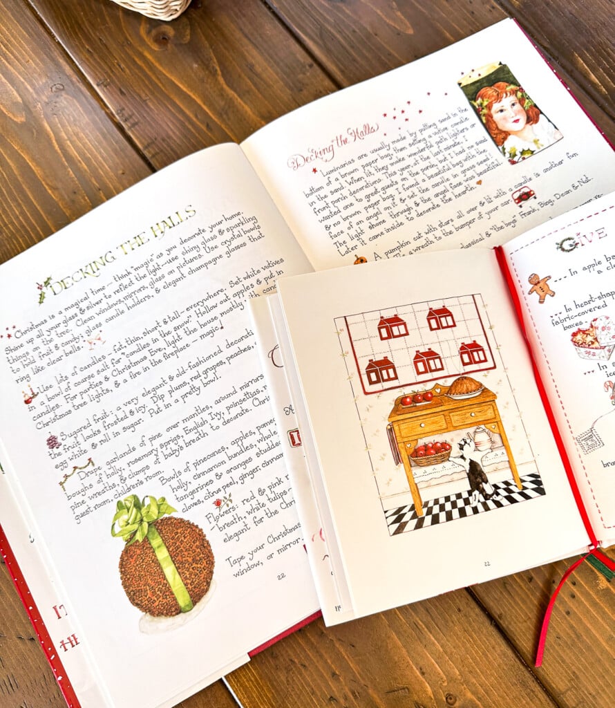 Susan Branch's illustrated Christmas books opened up on a table.