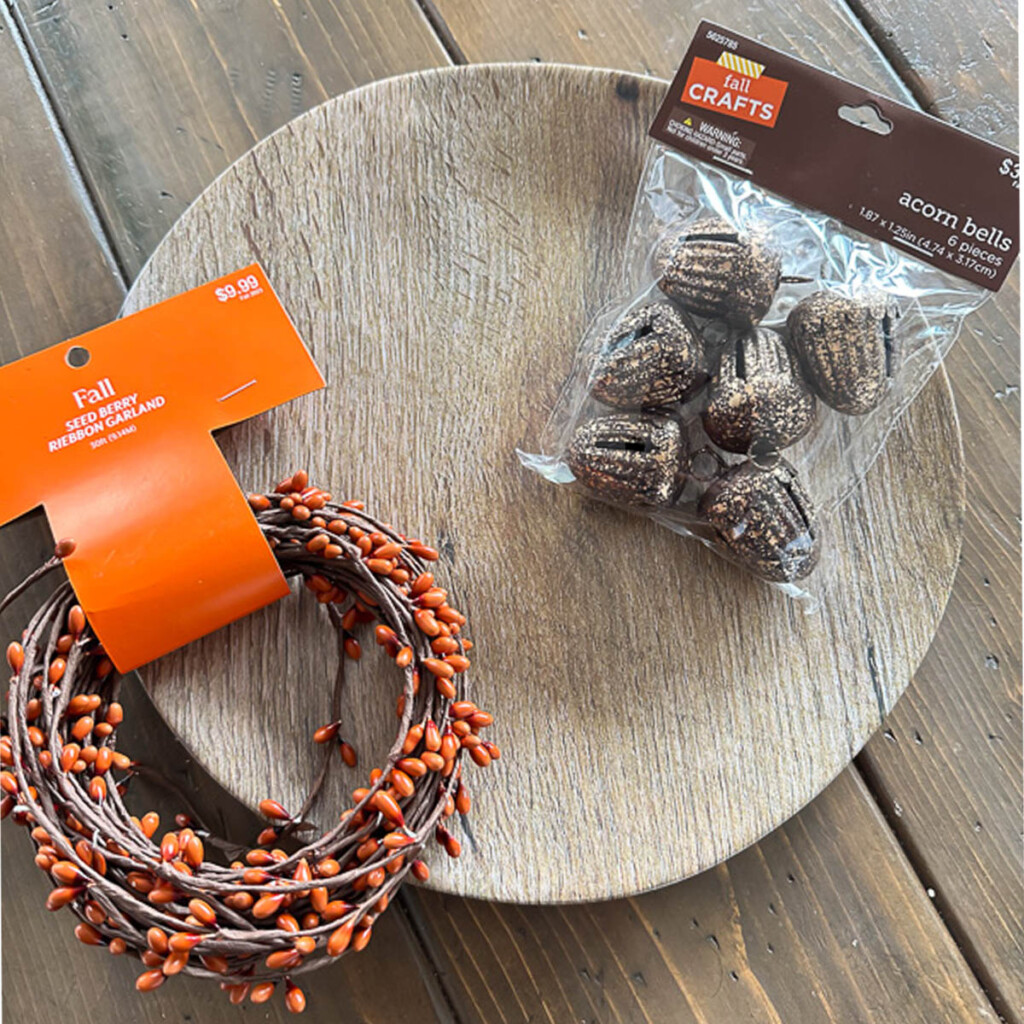 Hobby Lobby Fall finds. Wood look Melamine dinner plates, see berry ribbon garland and acorn jingle bells.