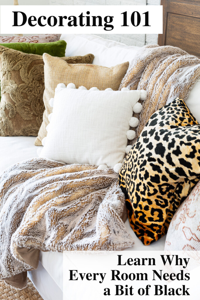 Decorating 101: Learn why every room needs a bit of black. Photo is of a white sofa with brown, white and black accents.