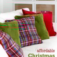 Affordable Christmas decorating ideas. Red, green and plaid pillows on a white sofa.