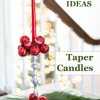 Red Christmas ornaments on a taper candle holder. Text overlay says Christmas Styling Ideas Taper Candles.