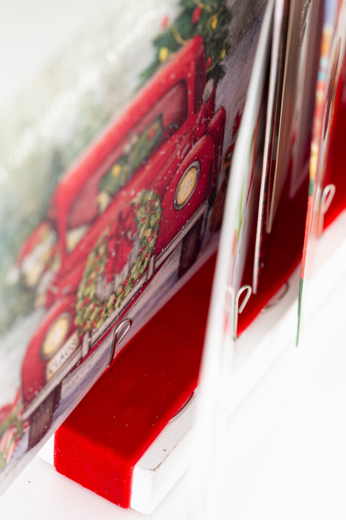 close up showing how to attach Christmas cards to card holder.