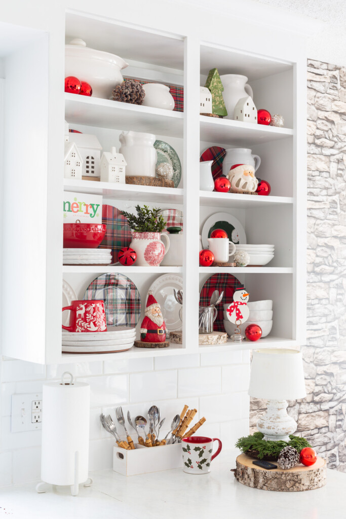 Red and and white DIY Christmas shelf decor in a kitchen with some accents of green.