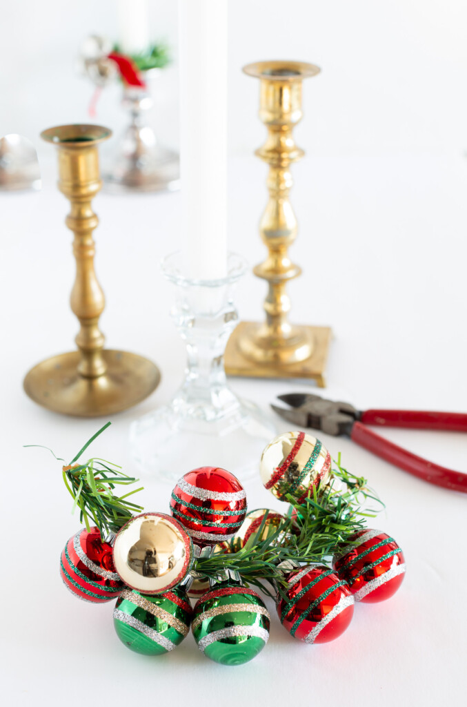 How to make a holiday taper candle ring using miniature Christmas ornaments.