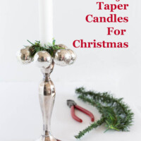 silver candle holder with small silver ornament decoration around the collar. Text overlay says - creative ways to style taper candles for Christmas