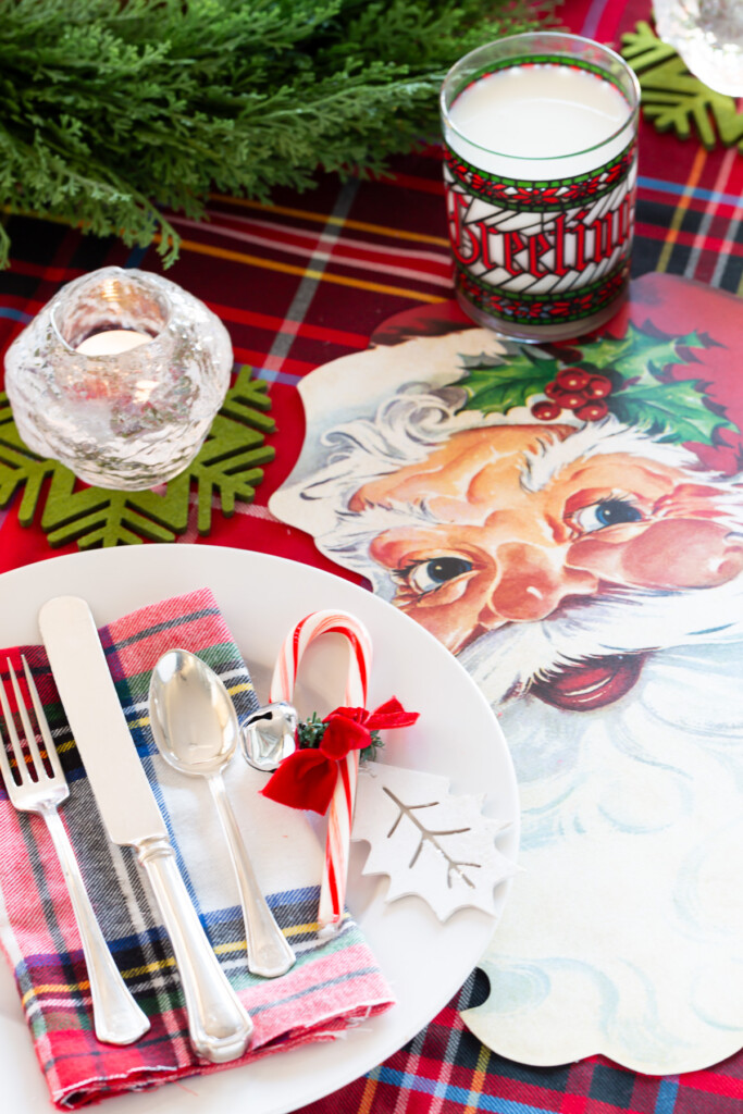 kid-friendly christmas table setting idea with candy canes and Santa face paper placemats.