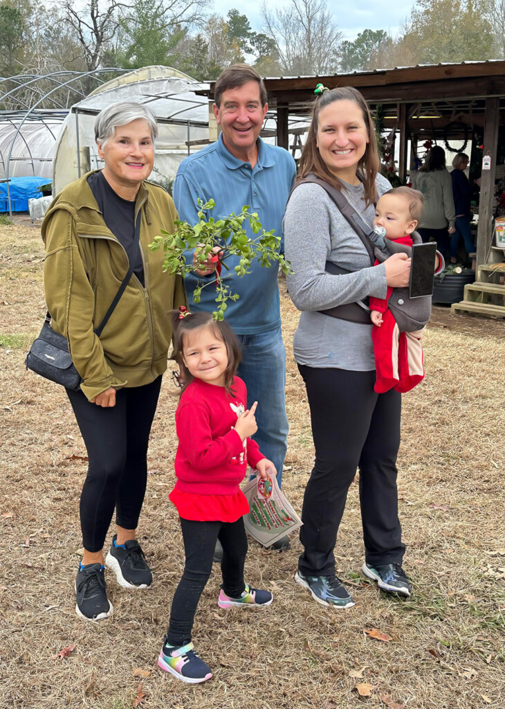 family buying a Christmas tree at the lot