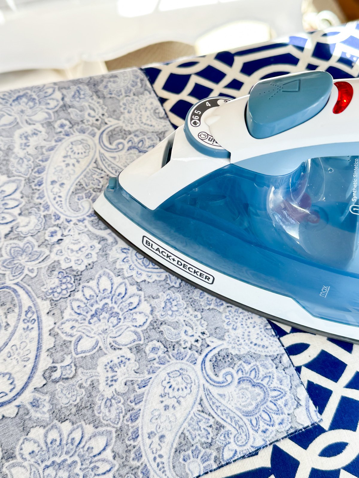 an iron pressing fabric that is being made into a cloth napkin