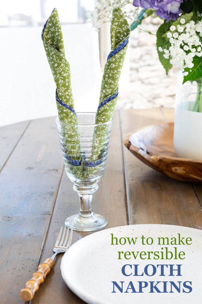 how to make reversible cloth napkins. Finished green and blue print napkins rolled into a bunny ears napkin fold and placed in a stemmed glad