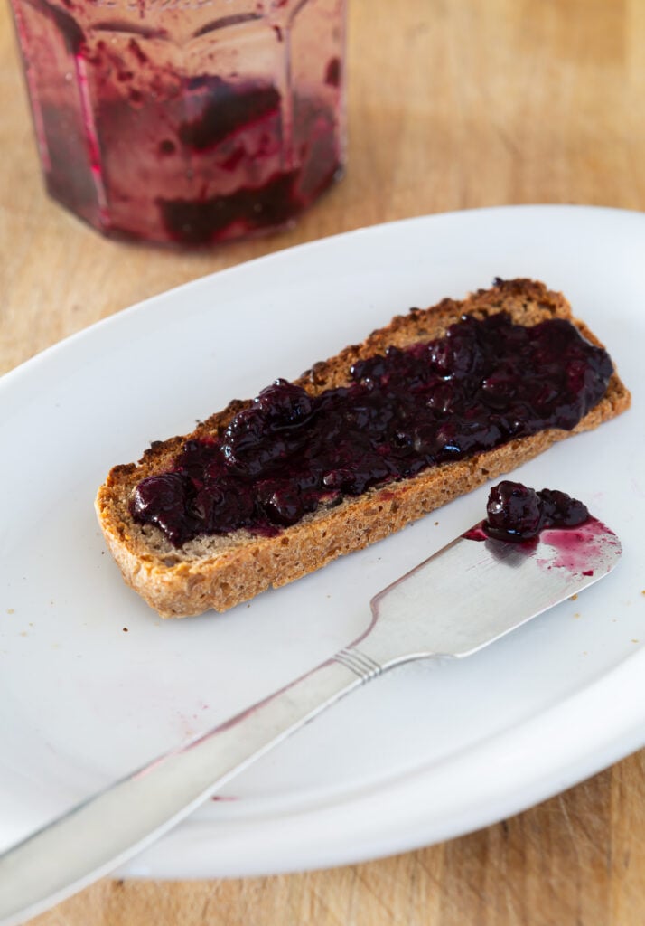 Healthy homemade jam spread on top of a slice of buckwheat toast.