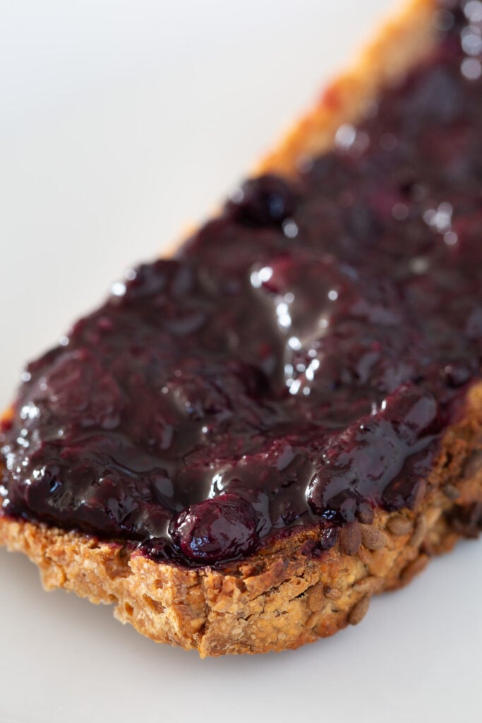 healthy no sugar jam spread on a piece of buckwheat toast.