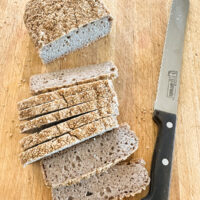 looking down at a loaf and slices of buckwheat bread.