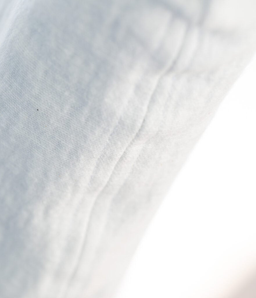 closeup of seam sewn on a diy dining room chair slipcover.