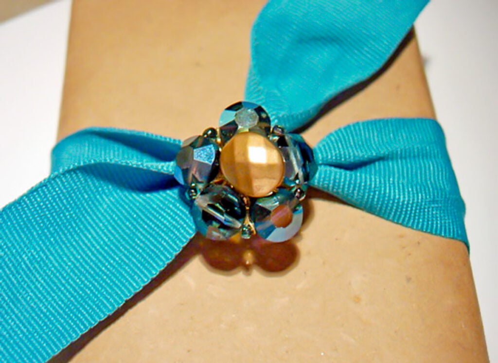 Gift wrapped with turquoise ribbon and a glass bead vintage clip on earring as an embellishment.