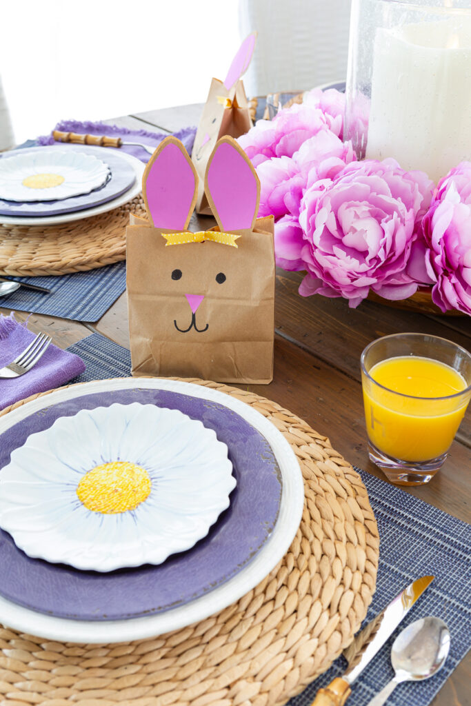 Easter table settings each with layered plates at each place setting.