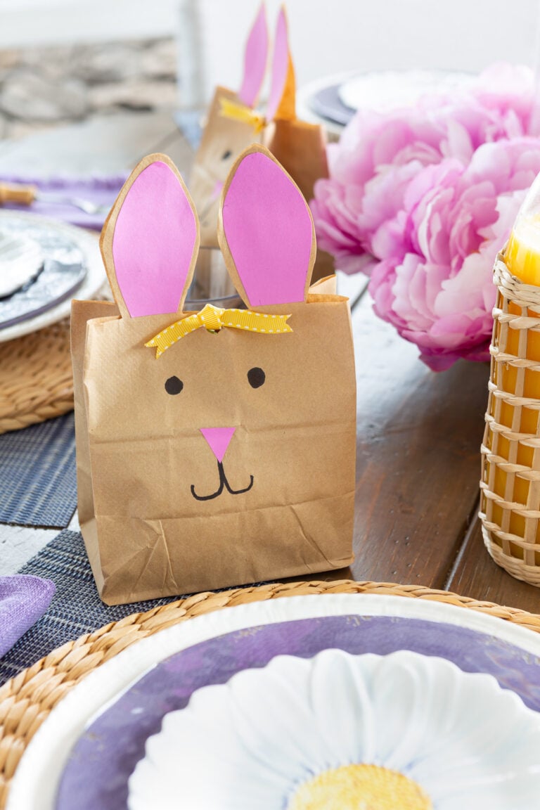 Easter bunny bags for Easter placed at each table setting on an Easter dining table set up for Easter brunch.