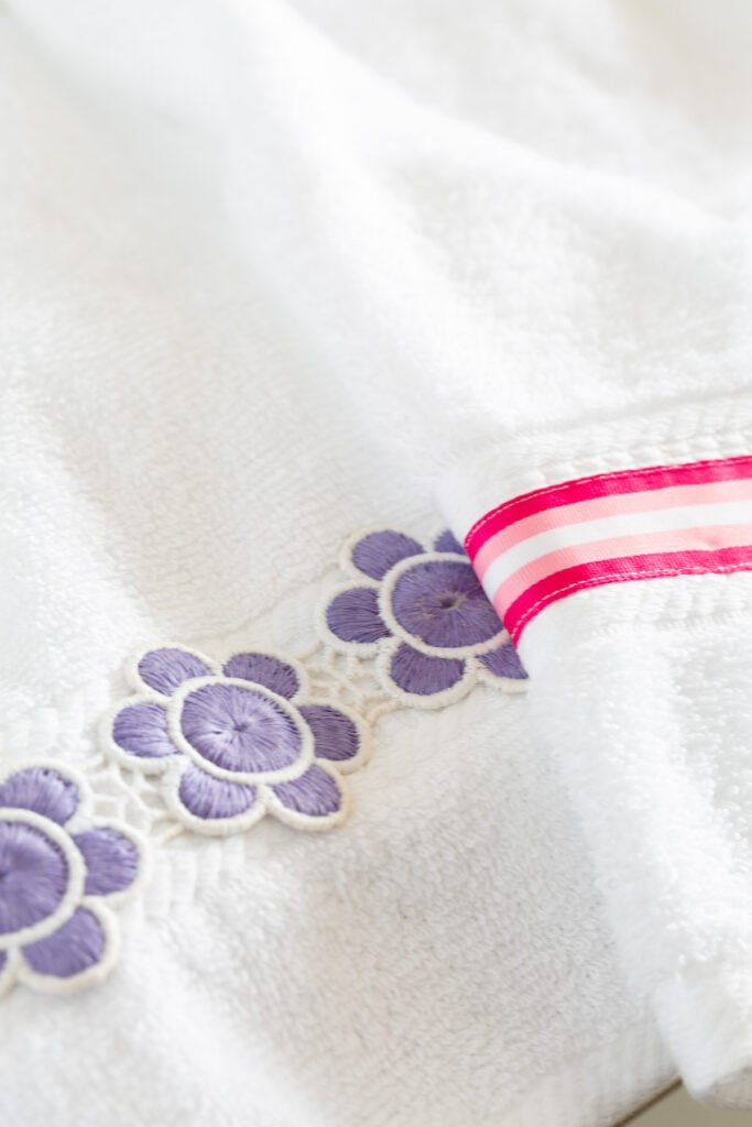 close up of two hand towels with decorative ribbon added for embellishment.