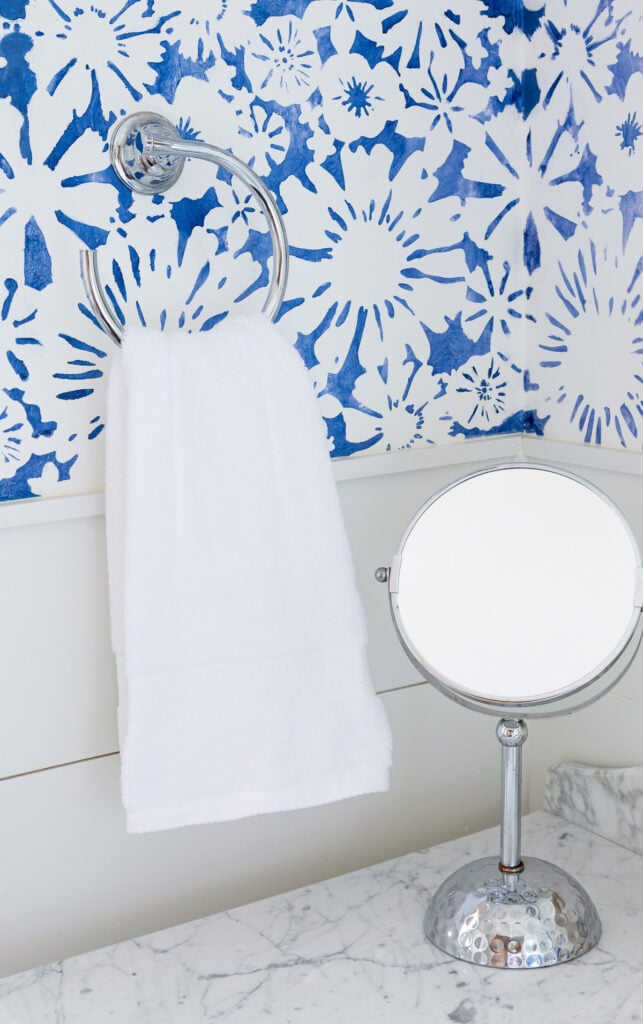 plain white bathroom hand towel hanging on a towel ring.