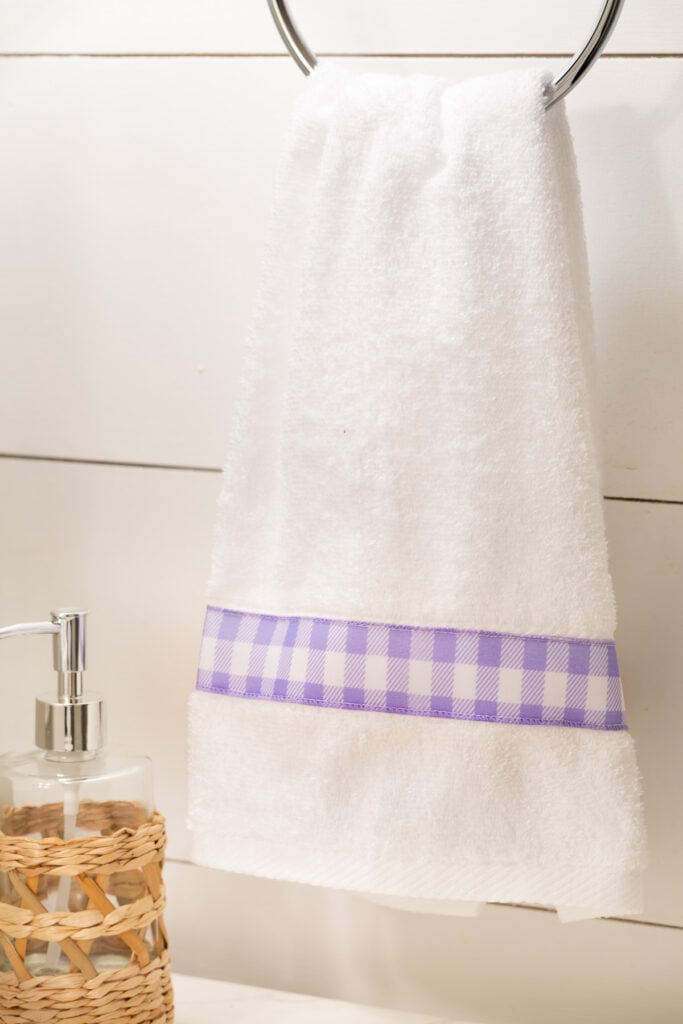 white towel with lavender and white check ribbon trim.