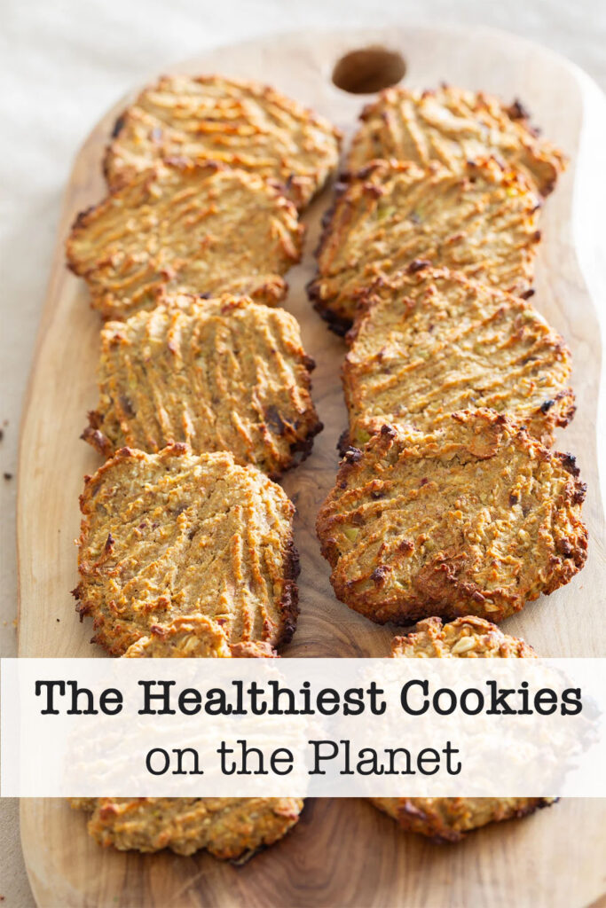 Healthy vegan cookies lined up in two rows on a cutting board.