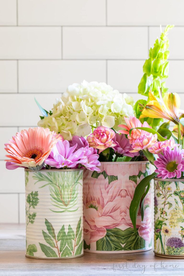 3 decoupage cans with flower napkins.