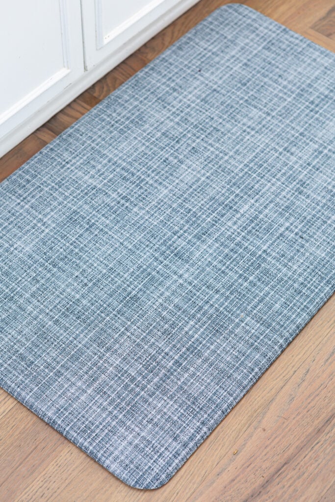 close up of blue Lucky Brand anti-fatigue wellness mat in kitchen.