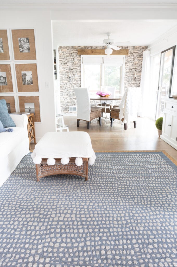 blue and white rug in a living room looking into a dining room.