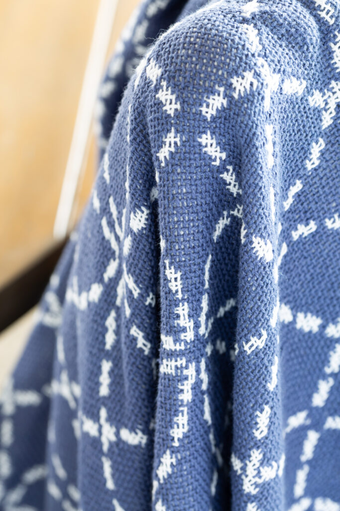 close up of blue and white cotton throw blanket