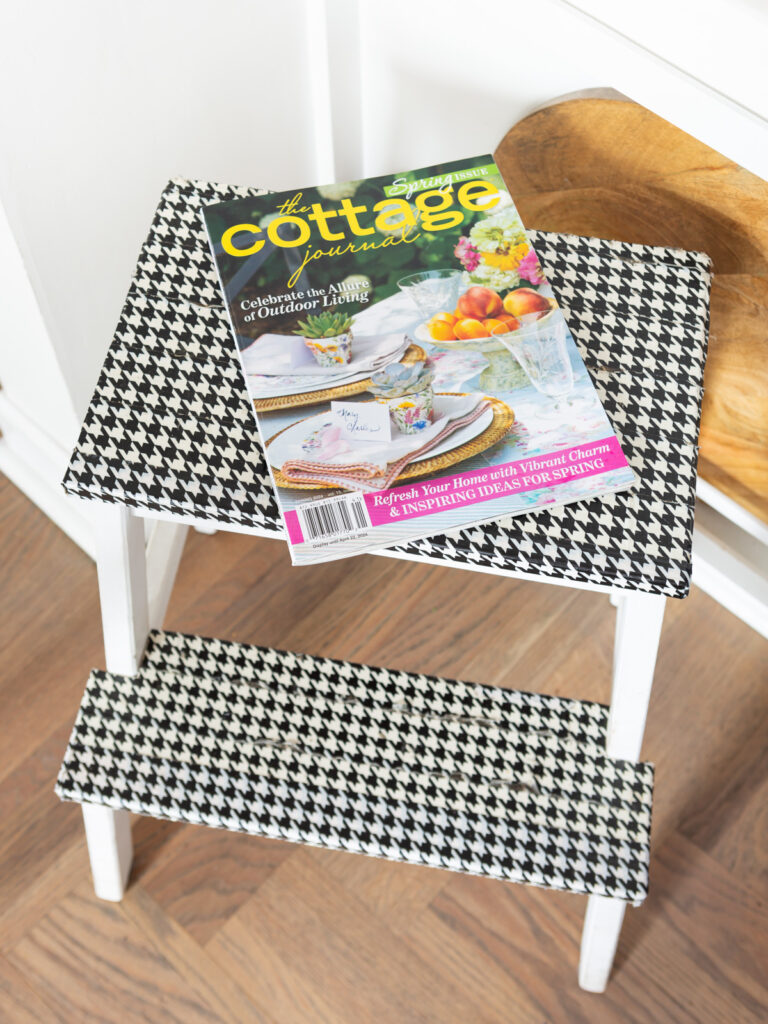 Spring decor magazine on a stool in a kitchen.