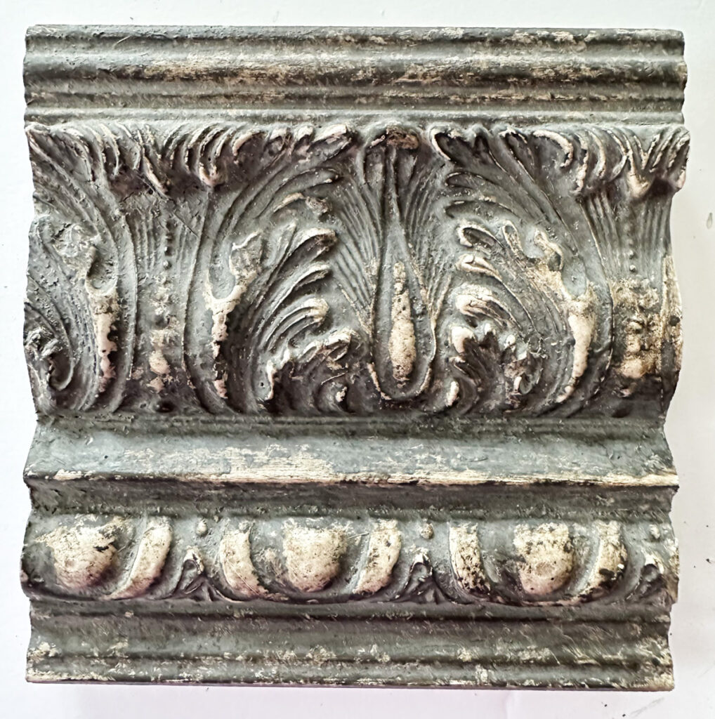 close up of decorative crown molding with an Amy Howard Home speciality finish to make it look old.