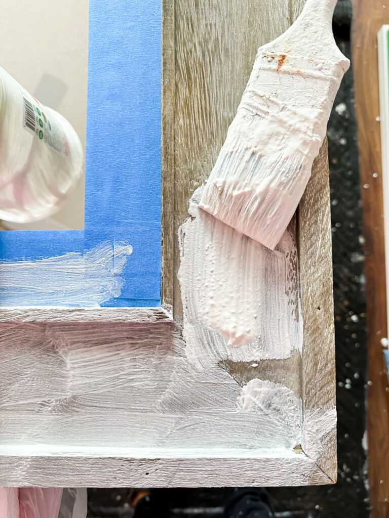 brushing on Vintage Plaster finish on raw wood mirror frame.