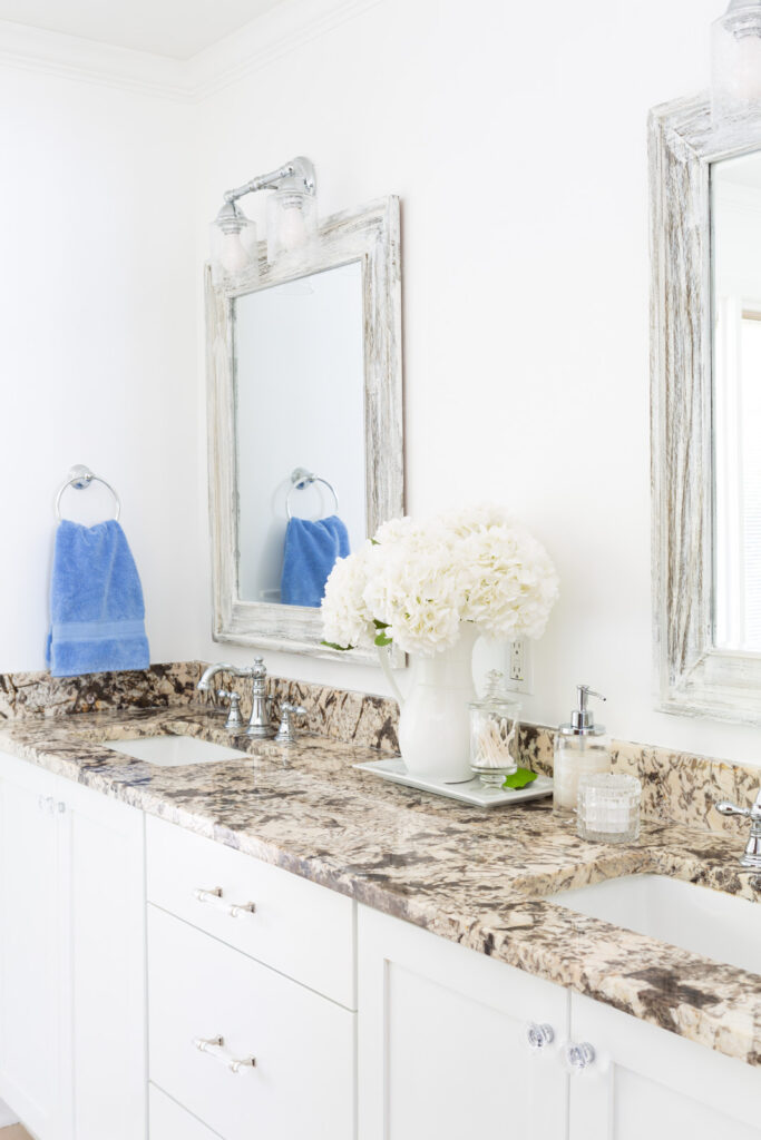 sky blue towels in towel ring in neutral color bathroom.
