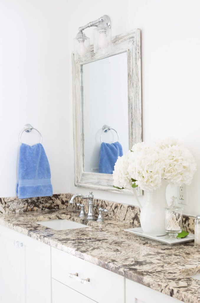 sky blue towels in towel ring in neutral color bathroom.