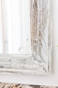 close up of Vintage Wood plaster on a rough wood surface mirror frame.