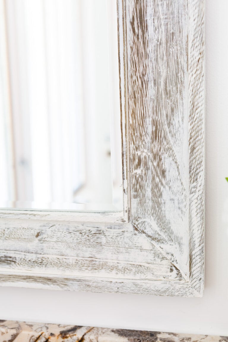 close up of Vintage Wood plaster on a rough wood surface mirror frame.