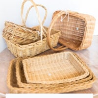 a collection of natural wicker baskets spread out on a table.