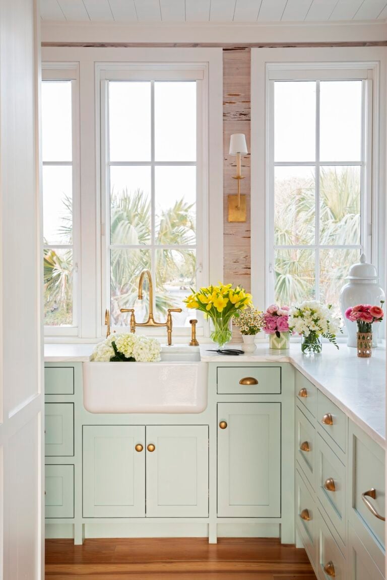 kay miller kitchen done in pale green, white with pretty flowers on counter.