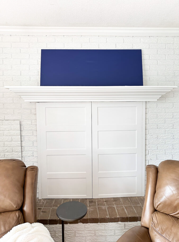 face on view of a white brick fireplace wall and mantel without anything on it.