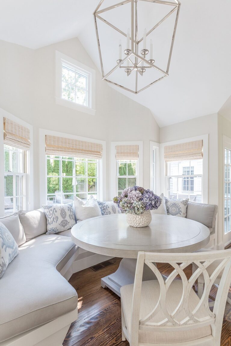 kitchen with large round banquette done in pale blue, white and beige.