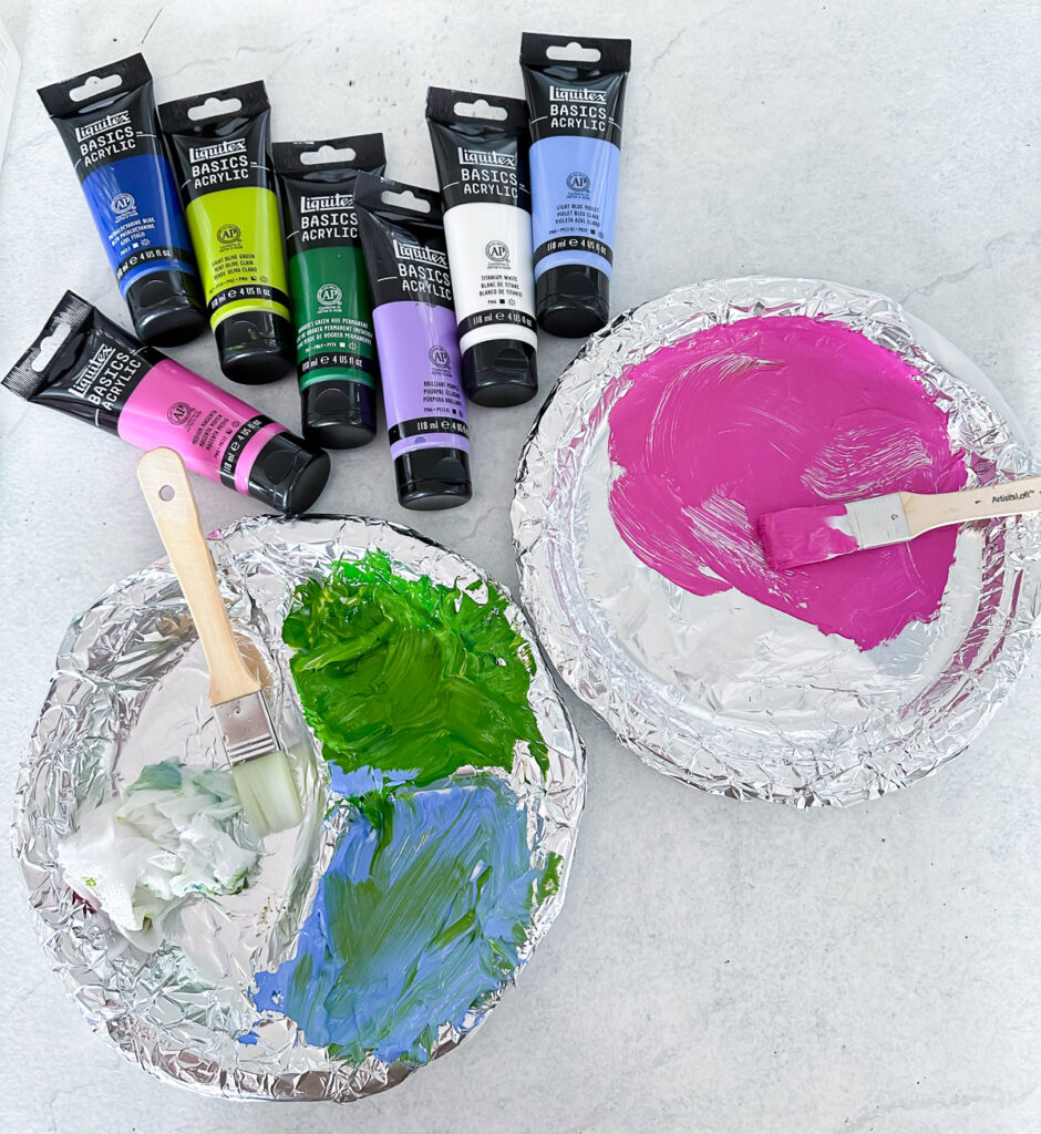 Two DIY acrylic paint palettes made using foil and paper plates.