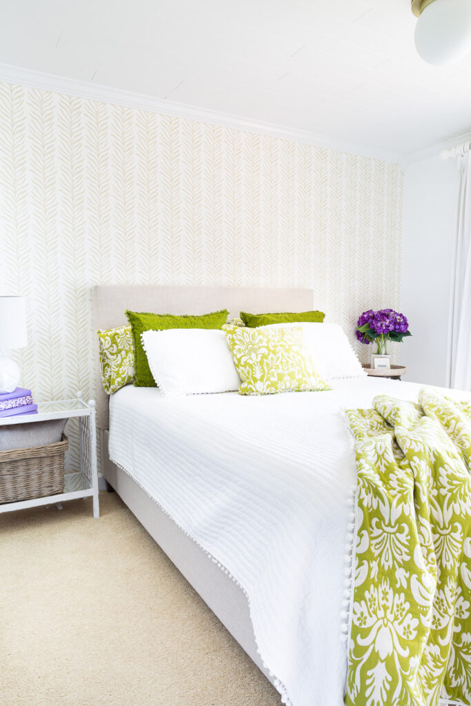 Long view of bedroom after accent wall was covered with Love vs Design wallpaper.