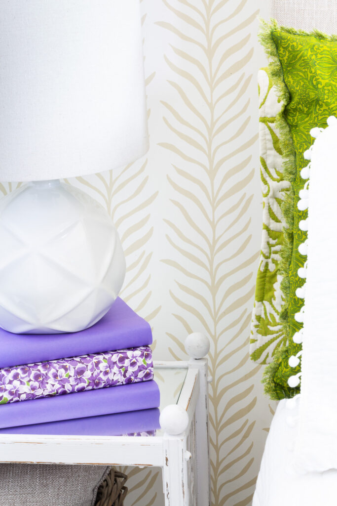 Close up photo of Love Vs Design Glissade wallpaper on a bedroom wall in the pattern Vine Thread.