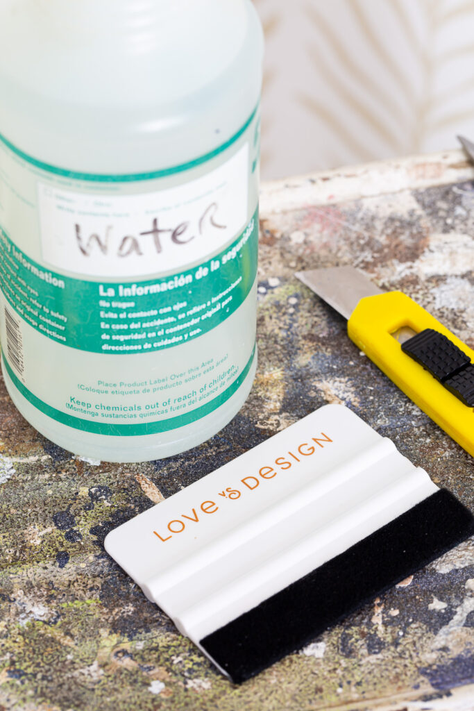 Close up of Supplies needed to install Love vs Design wallpaper.