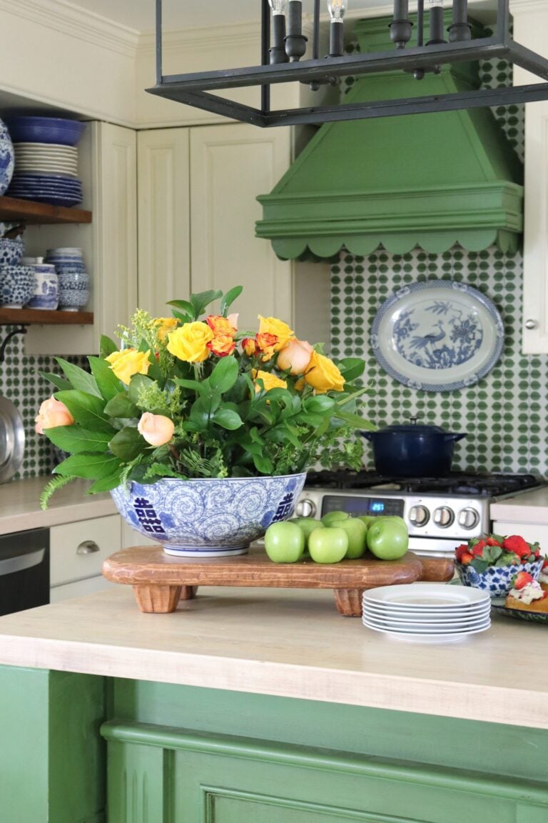 Green and white kitchen with blue accents.