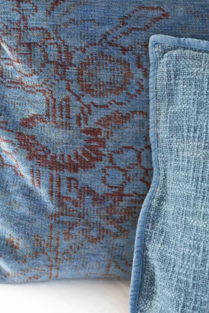 close up of dyed throw pillow covers. They were tan/brown now they are a denim blue color.