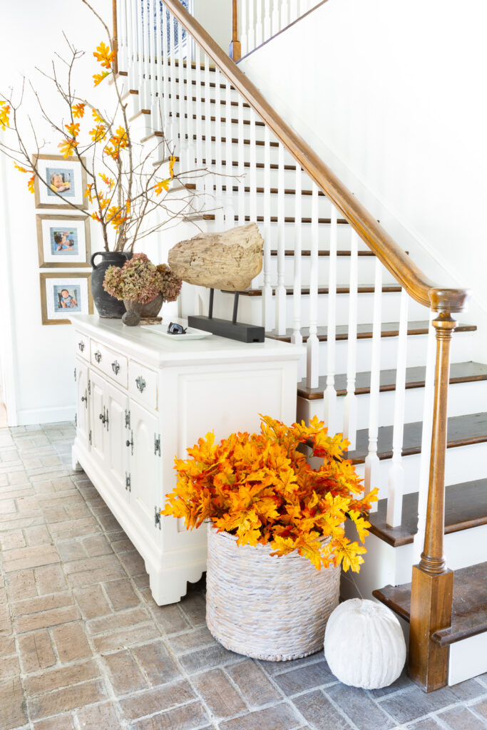 home entrance foyer decorated for fall with faux branches